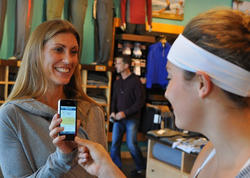 Woman showing a coupon on a phone