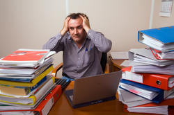 Man with too much paperwork