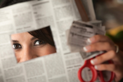 Woman cutting coupons