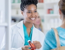 Cheerful pharmacist talks with customer