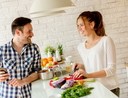 Young couple preparing healthy meal in the kitchen