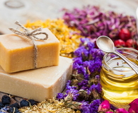 Bars of homemade soaps, honey or oil and healing herbs