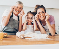 Grandmother, mother and daughter having fun in the kitchen