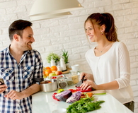 Young couple preparing healthy meal in the kitchen